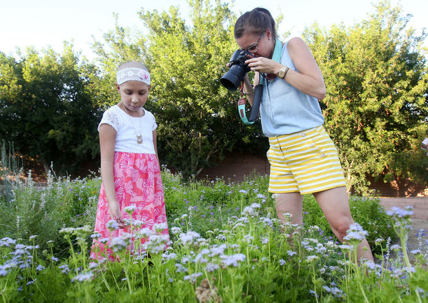 Patricia, 9, plays with the flowers as Lindberg takes her photo. Patricia was diagnosed with acute lymphoblastic leukemia, and is undergoing chemotherapy.